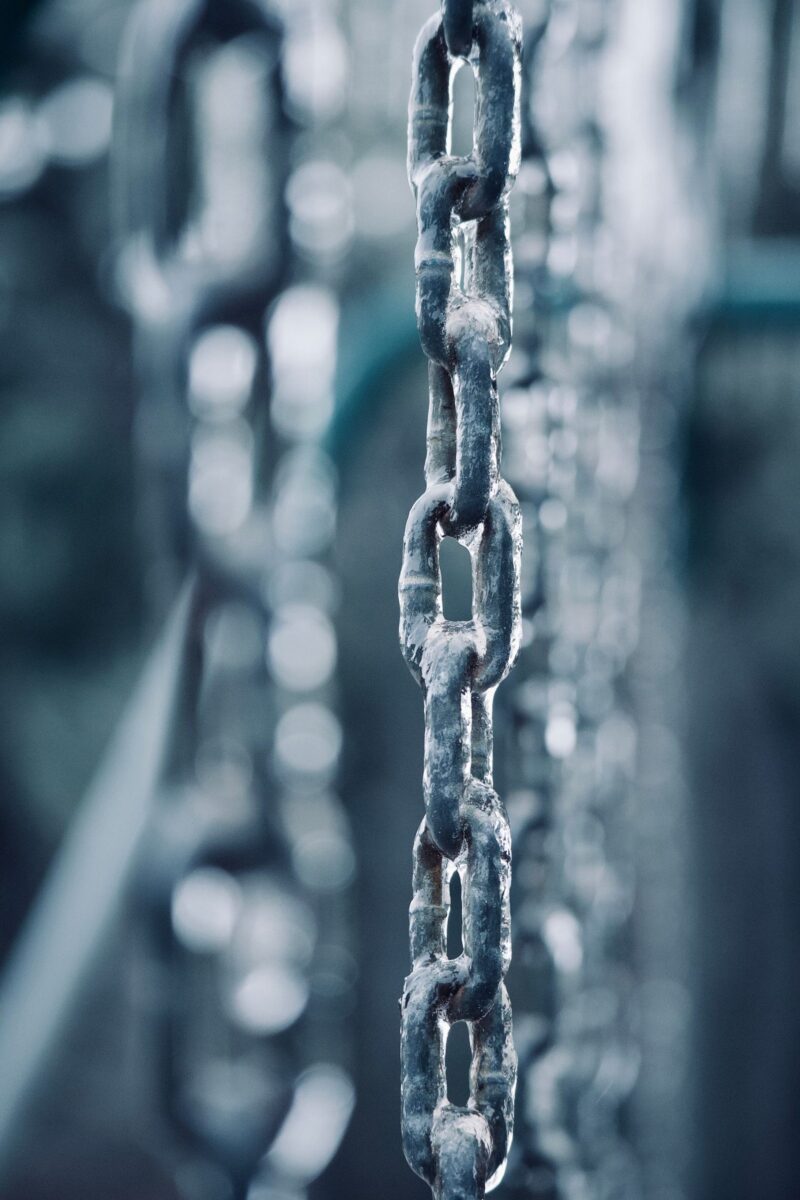 A close-up photograph of rusted metal chains