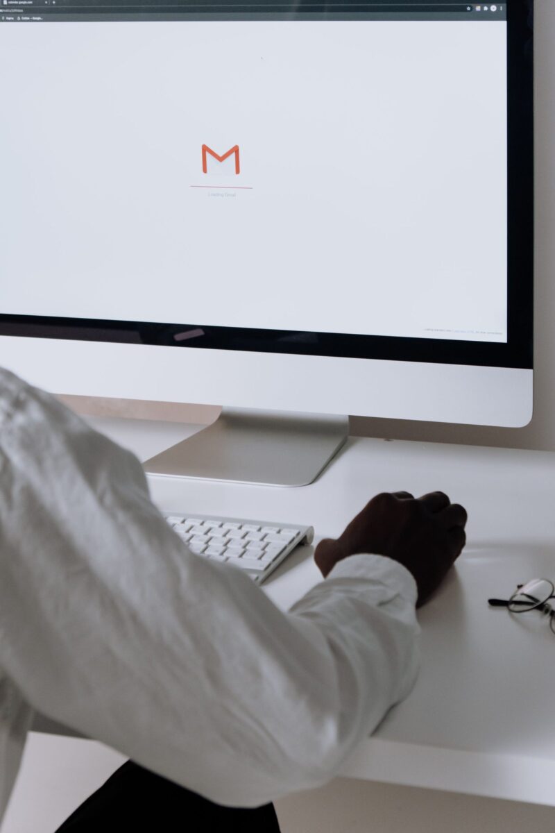 A desk with an email inbox open on screen, ready for manual publisher outreach